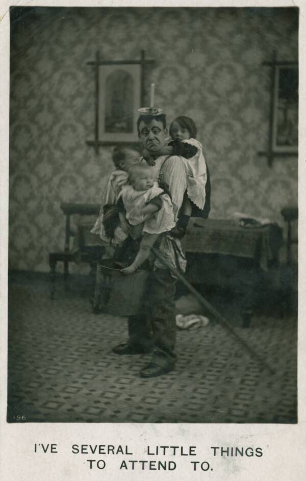 Man In An Apron Holding Children