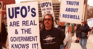 A Group Of Protestors March In Front Of The Genera