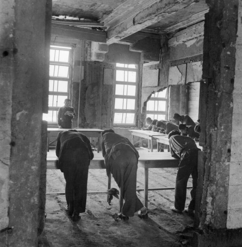 Men Deliberate In Hiroshima Ruins