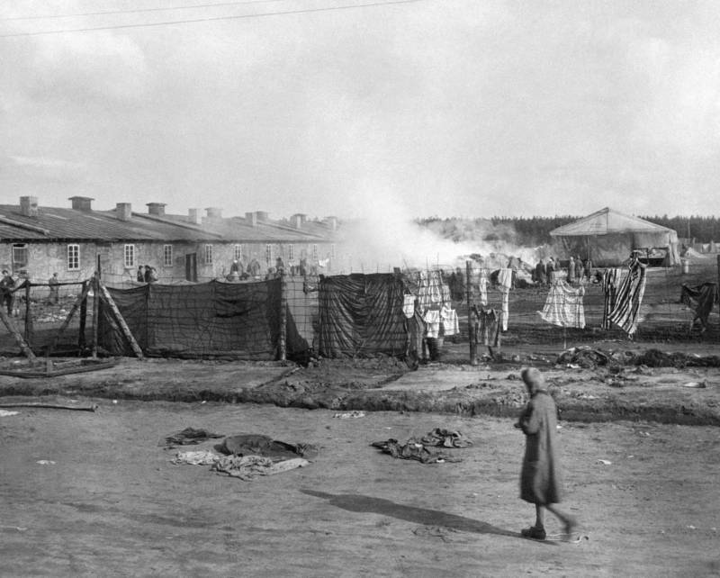 Prisoner Walks Along Barracks At Bergen-Belsen