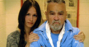 Afton Burton Holds Mansons Shoulders