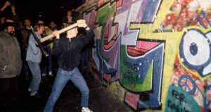 Man Takes Axe To Berlin Wall