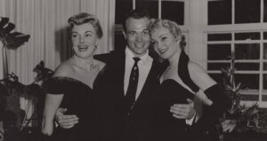 Bowers With His Arms Around Two Women