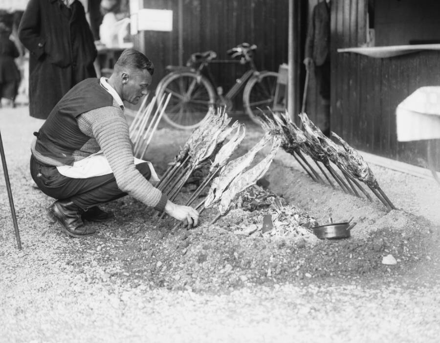 Man Grilling Herrings At Oktoberfest
